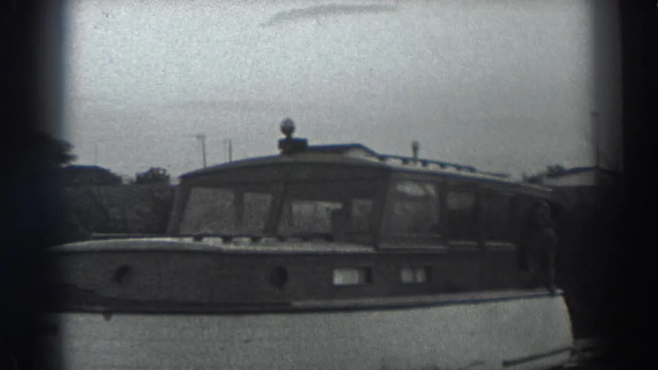 The Fort Ross 1938 footage shows the side of a cabin motorboat, with a person partly visible near the right edge.
