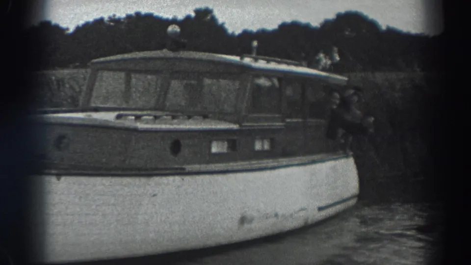 The 1938 Fort Ross home movie shows the motorboat from an angled view, with a person partly visible at the far right side.