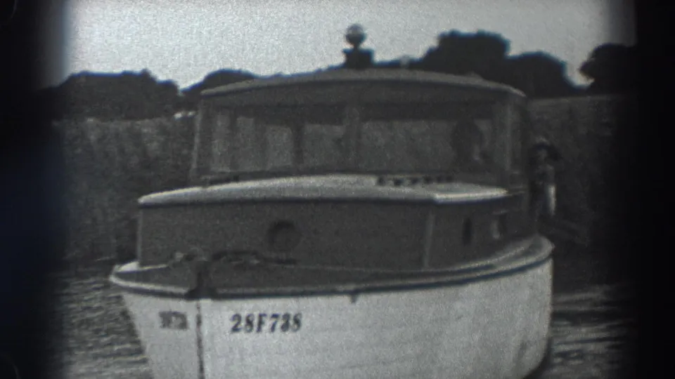 Fort Ross 1938 8mm frame showing the cabin boat close to camera, with a person visible near the right side.