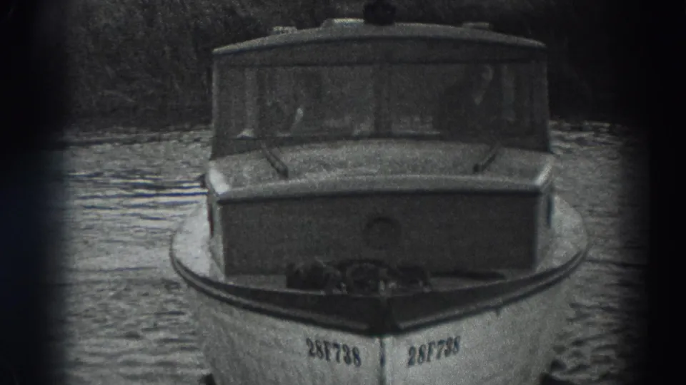 Fort Ross 1938 frame showing the small cabin boat closer to camera, with dark windows and visible bow number.