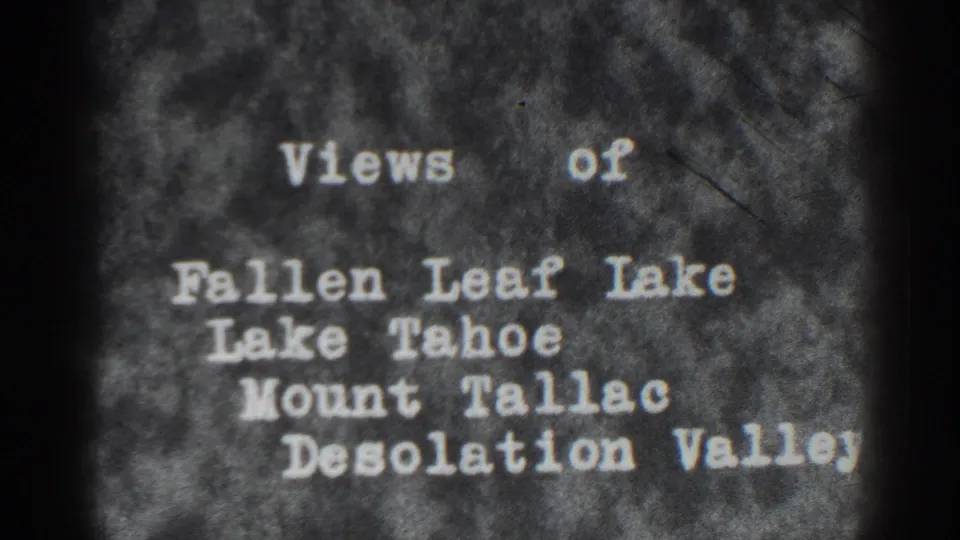 A second view of the 1938 Tahoe-area title card, with soft focus, grain, and dark frame edges around the typed location list.