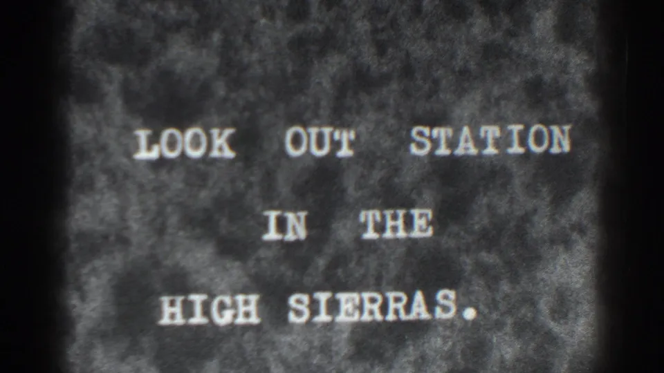 1938 8mm title card reading LOOK OUT STATION IN THE HIGH SIERRAS on a mottled dark background.