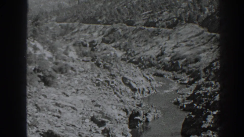 1938 8mm view near Oroville, California, showing a rocky stream winding through a steep canyon landscape.