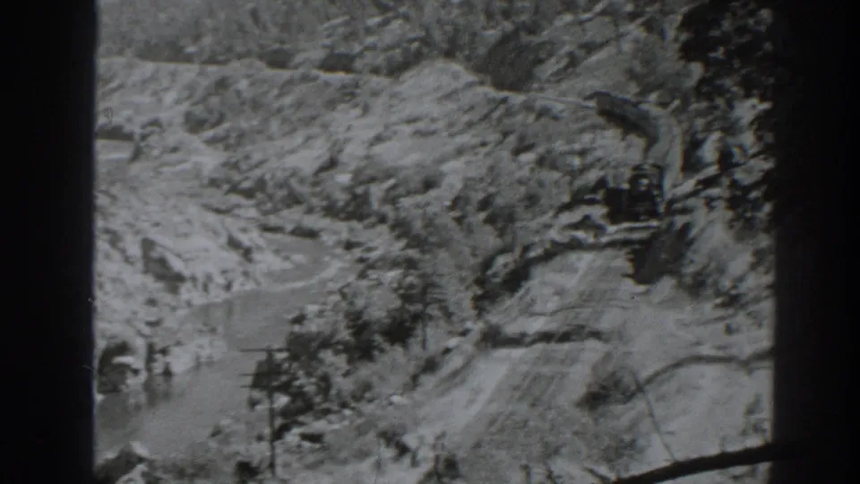 The camera looks over a winding river canyon near Oroville, California, with rail alignment visible along the rugged slope.
