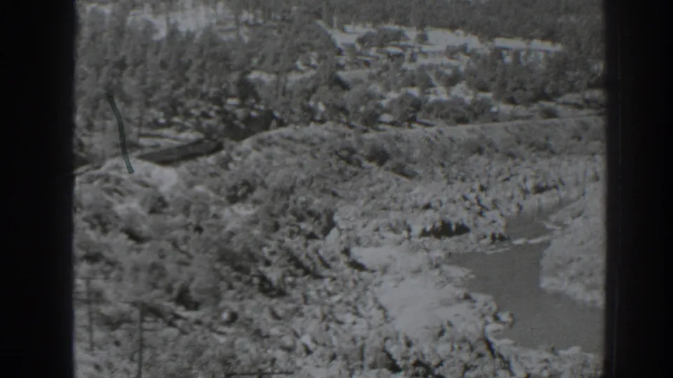 Late clip frame widens to a rocky Oroville-area river valley, with water below, trees on slopes, and distant terrain.
