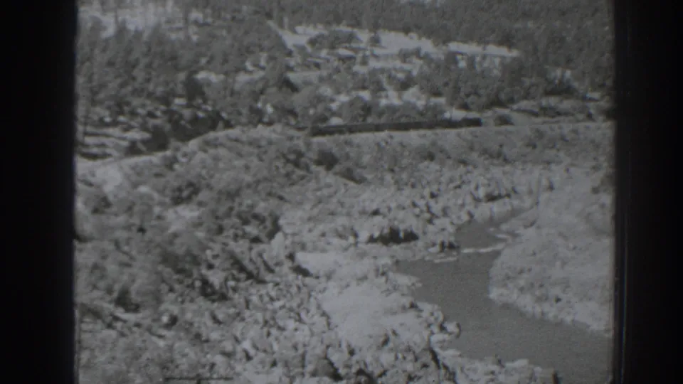 Black-and-white 8mm view near Oroville, California, with a river curving through rocky banks and sparse trees.