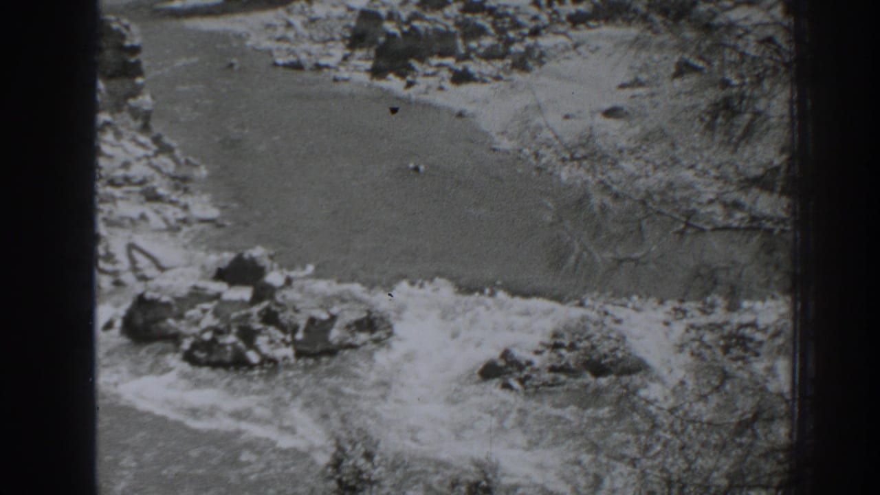 Rocky river channel with fast water moving around boulders.