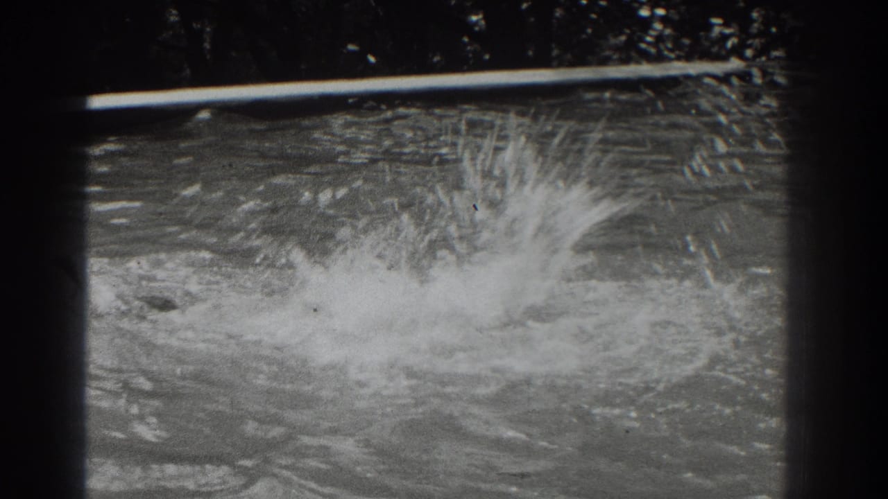 Large splash rises from pool water near the center of the frame.
