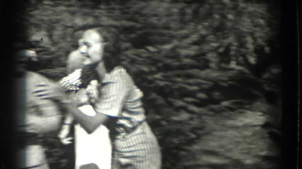In 1937 Southampton home-movie footage, two women appear to steady or spin another woman during a playful park scene.