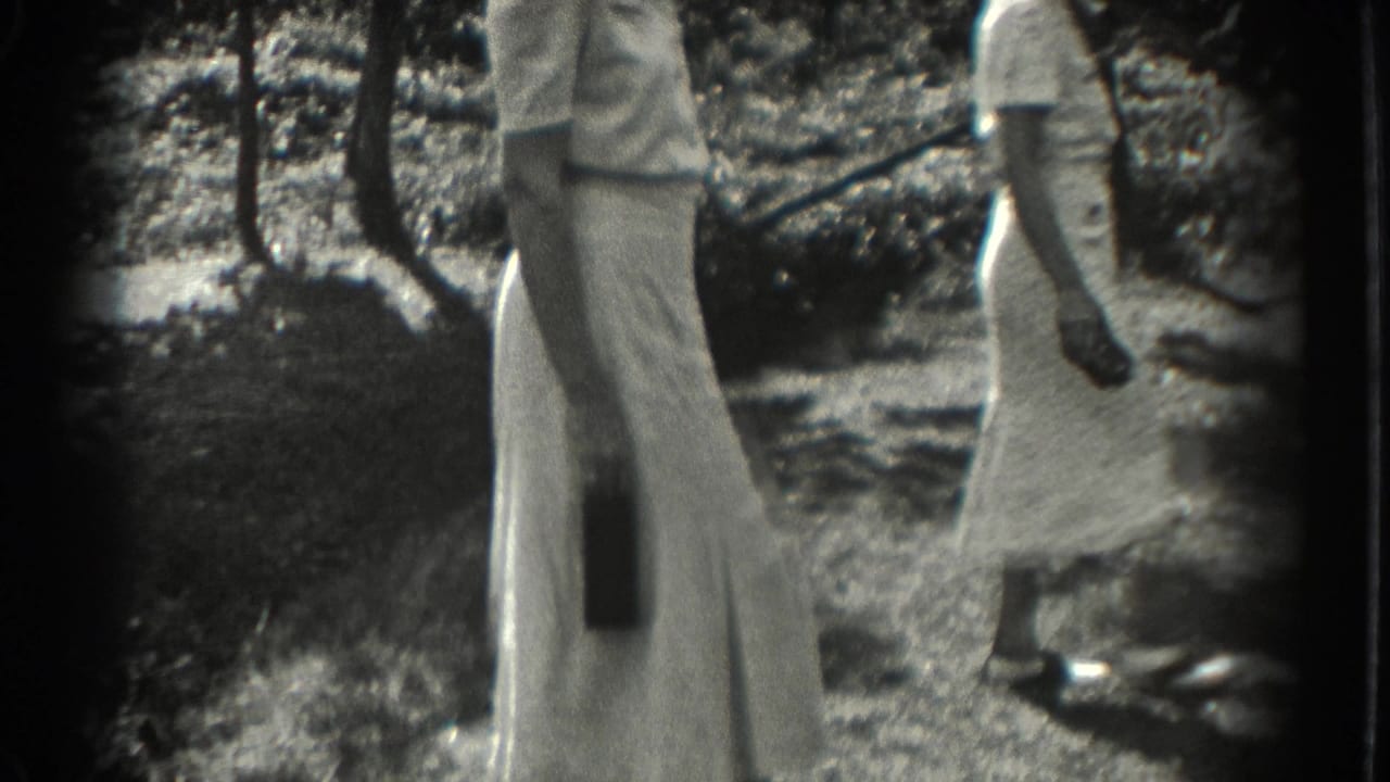 Women walk past each other outdoors, partly cropped by the frame.