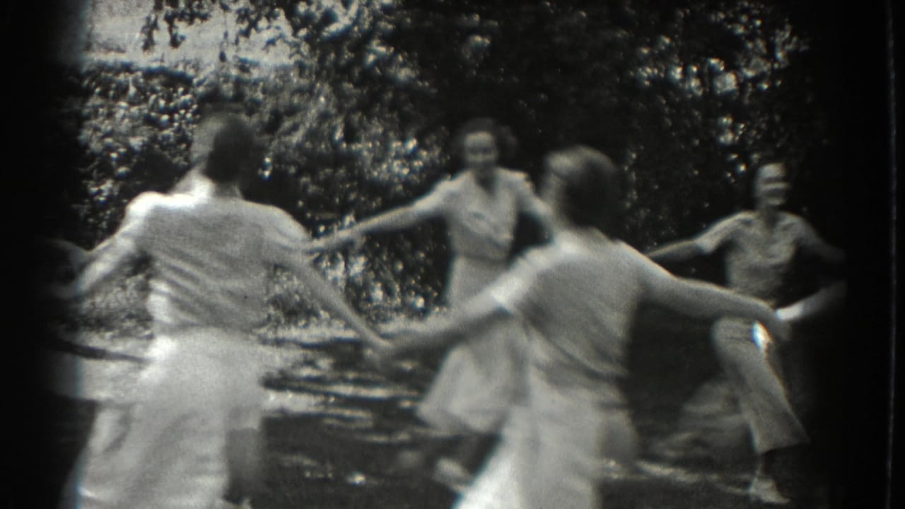 Circle of women and girls turning together outdoors.