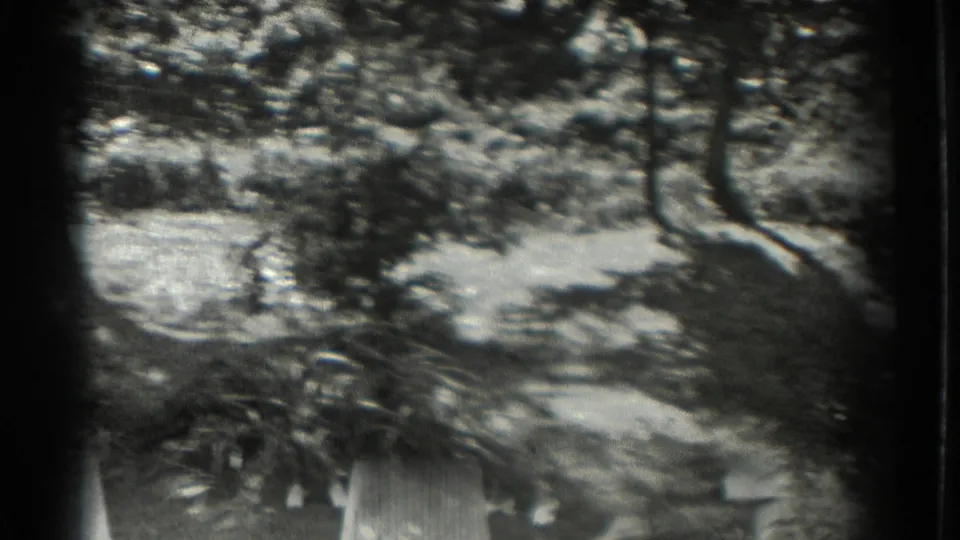 The 1937 home-movie footage shows a leafy park-like area in Southampton, with low plantings and a bright clearing under tree shade.