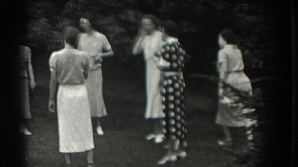 In Southampton, New York, 1937, women in summer dresses gather on a lawn during an outdoor circle game.