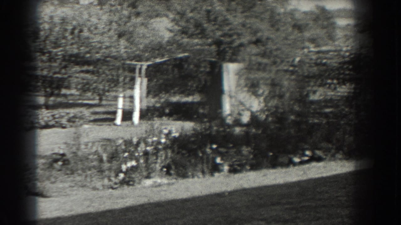 Black-and-white 1937 Southampton garden frame with planted beds, trees, lawn, and a simple trellis or arbor.