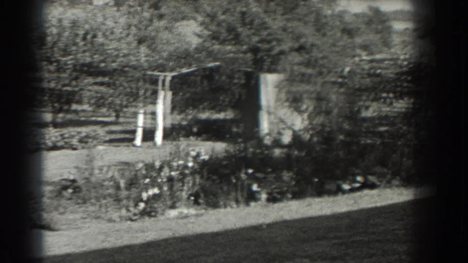 Black-and-white 1937 Southampton garden frame with planted beds, trees, lawn, and a simple trellis or arbor.