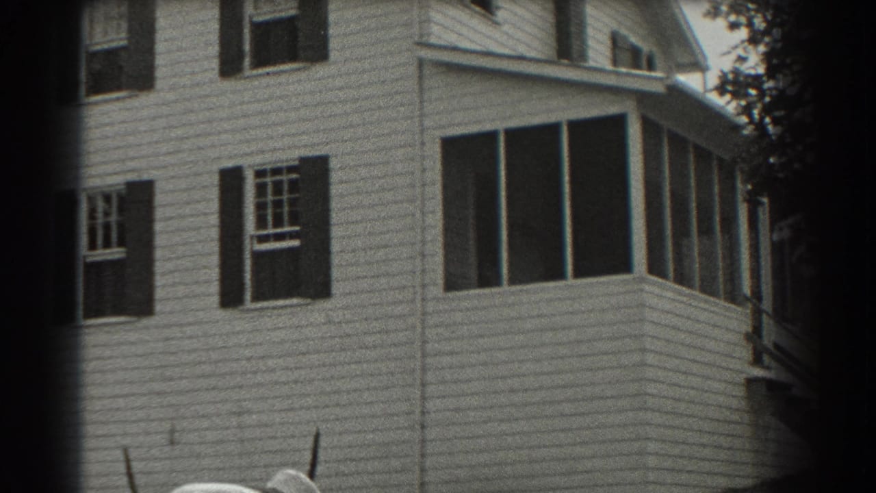 White clapboard house with dark shutters and a screened porch.