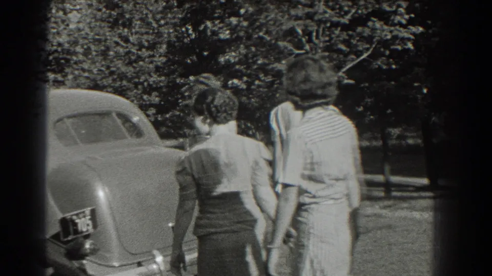 The final frame shows two women walking away beside a parked 1930s automobile in a leafy Southampton street setting.
