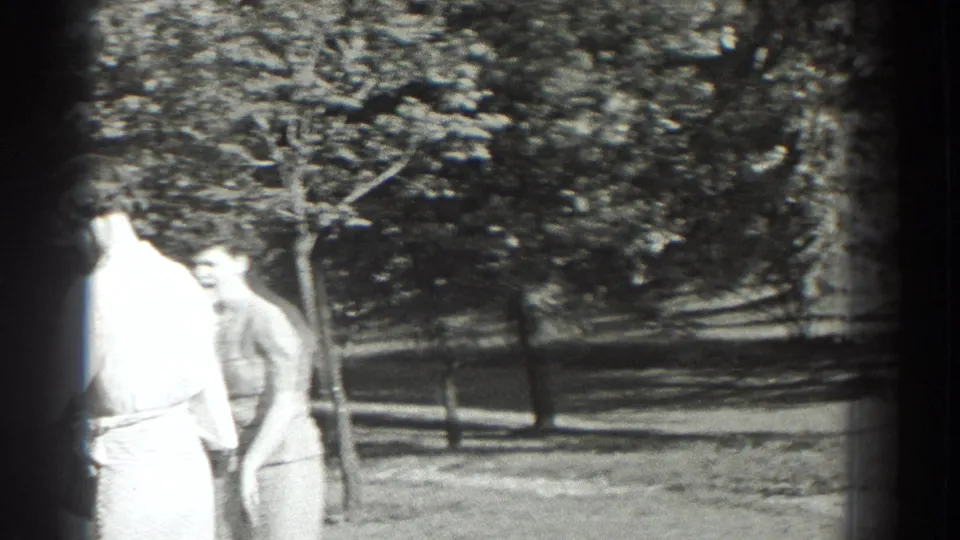 Two adult women in dresses stand in a sunny Southampton, New York yard in 1937 home-movie footage.