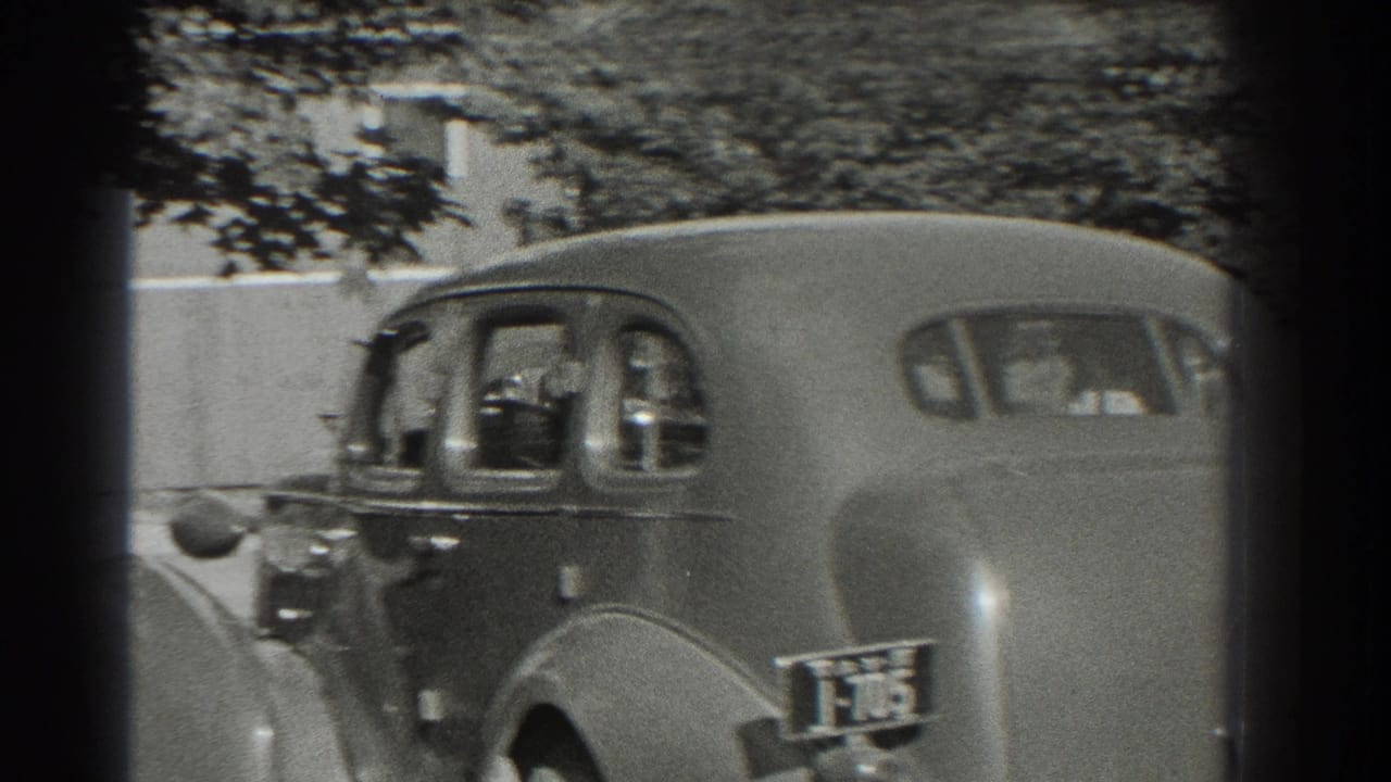 Rear and side views of two rounded 1930s sedans on a shaded street.