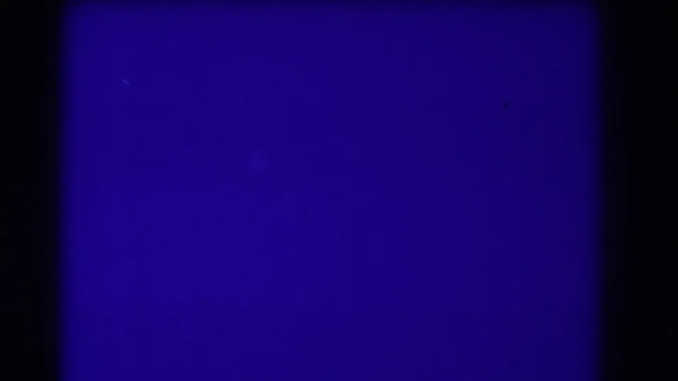 The scan shows a blue leader-like frame with a dark horizontal divide and visible film-gate borders.