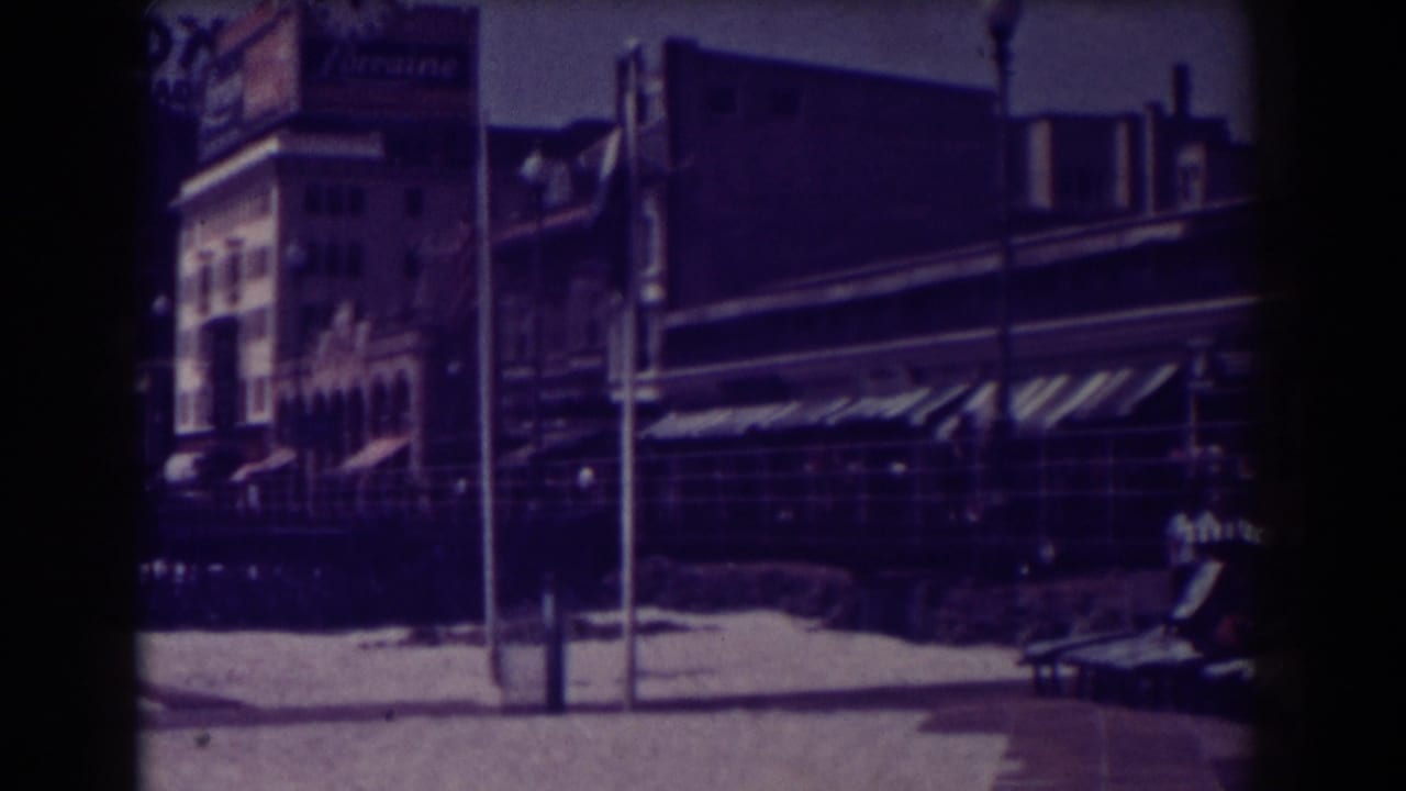Boardwalk storefronts with awnings, poles, and a Lorraine sign.