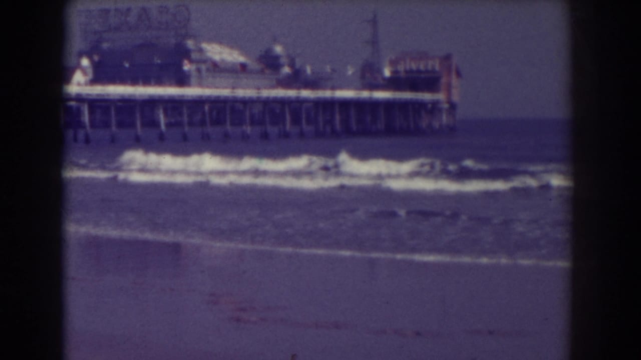 Atlantic City pier with ocean waves and a Texaco sign in soft 8mm color.
