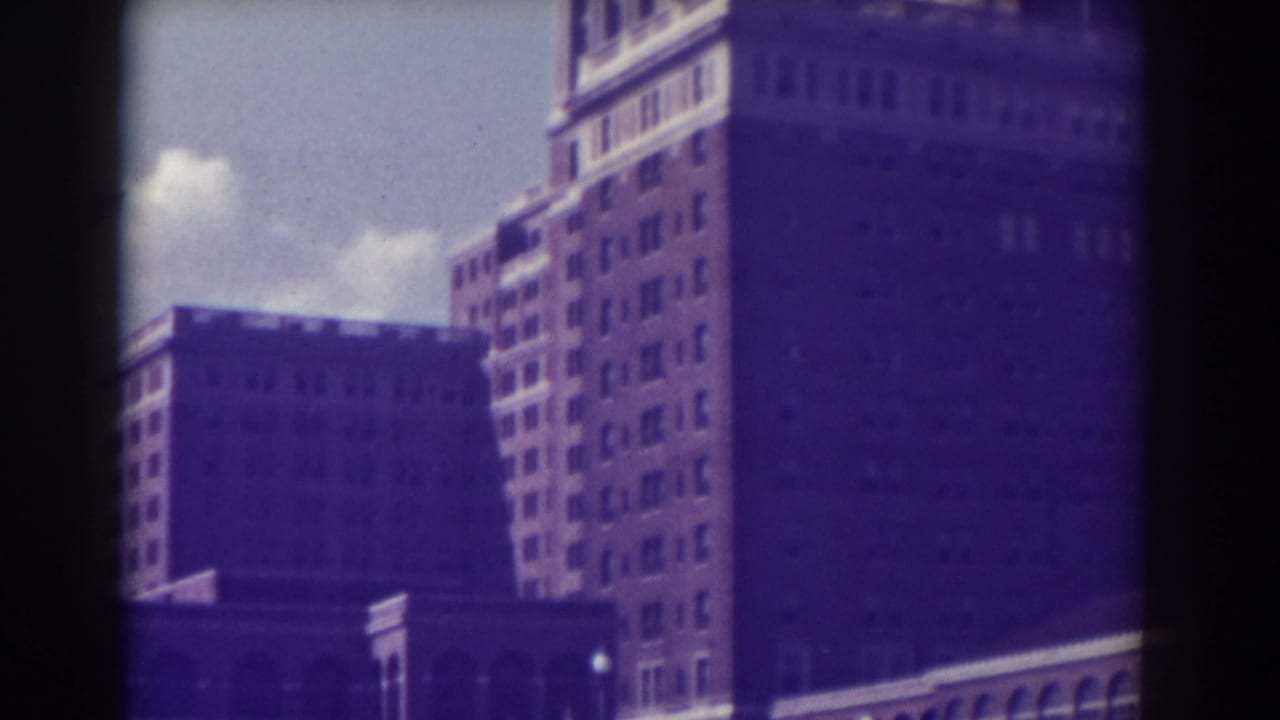 Upper stories of a tall building seen through dark 8mm frame borders.