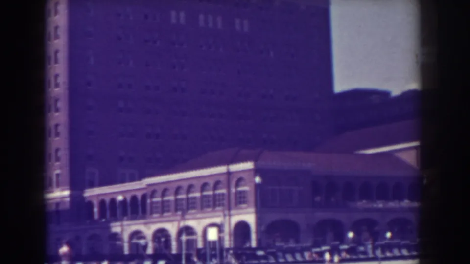 1938 Atlantic City view of the Brown Public City Library facade, with arched windows, parked cars, and a tall building in the background.