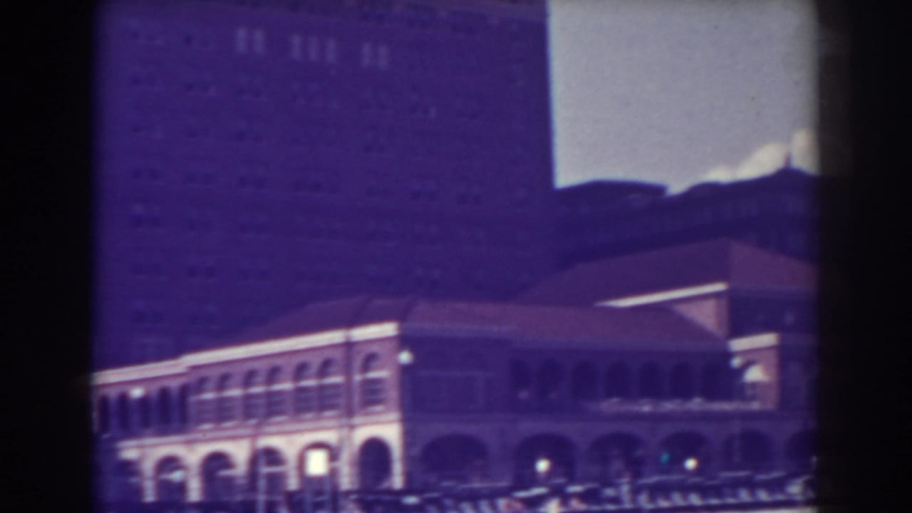 Atlantic City library exterior in 1938, showing the arched facade, roofline, cars, and pedestrians from a home-movie viewpoint.