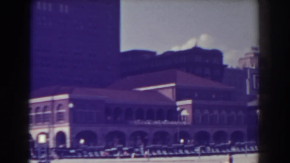 Late frame of the 1938 Atlantic City library view, showing the arched frontage, nearby building edge, cars, and pedestrians under a bright sky.