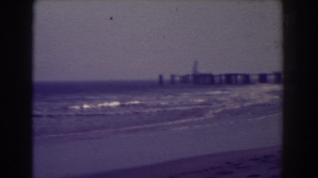 Soft 8mm frame of Atlantic City surf with a distant pier and sandy beach.