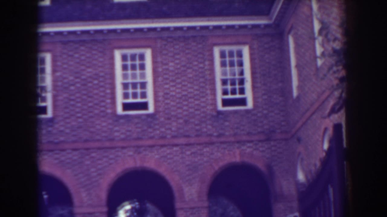 1938 Atlantic City exterior view of a brick building with sash-style windows and arched openings partly obscured by a dark frame.