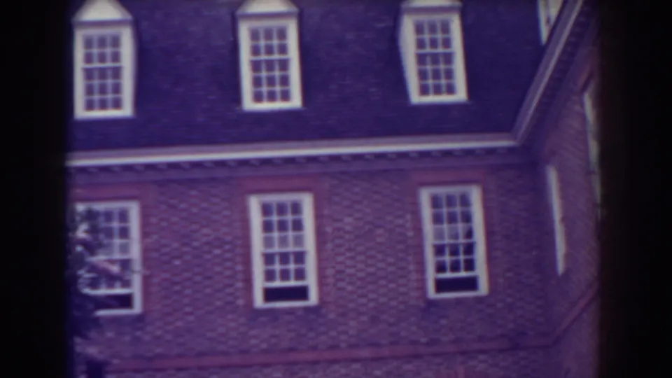 1938 Atlantic City frame showing the upper brick facade, dark roofline, and dormer windows of a manor-like exterior.