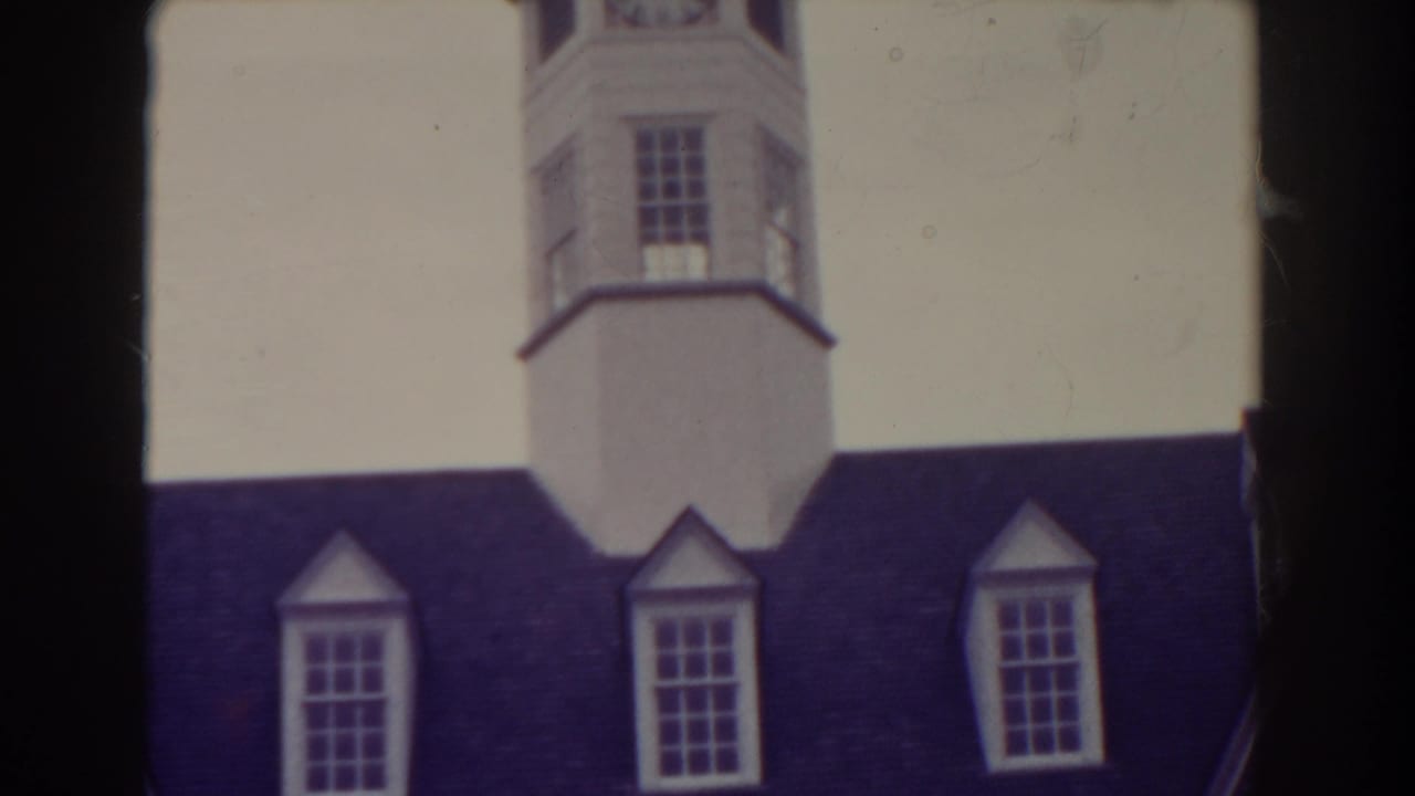 1938 Atlantic City frame with the upper white tower, dark roof, dormer windows, and pale sky seen through soft 8mm color.