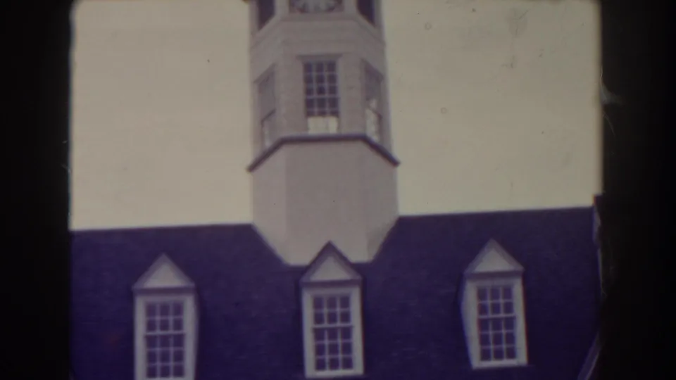 1938 Atlantic City frame with the upper white tower, dark roof, dormer windows, and pale sky seen through soft 8mm color.