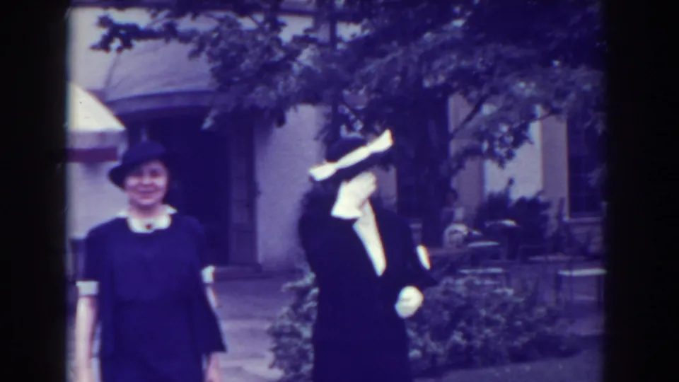 In the 1938 Atlantic City clip, the women approach in formal dress while one briefly covers or shields part of her face.