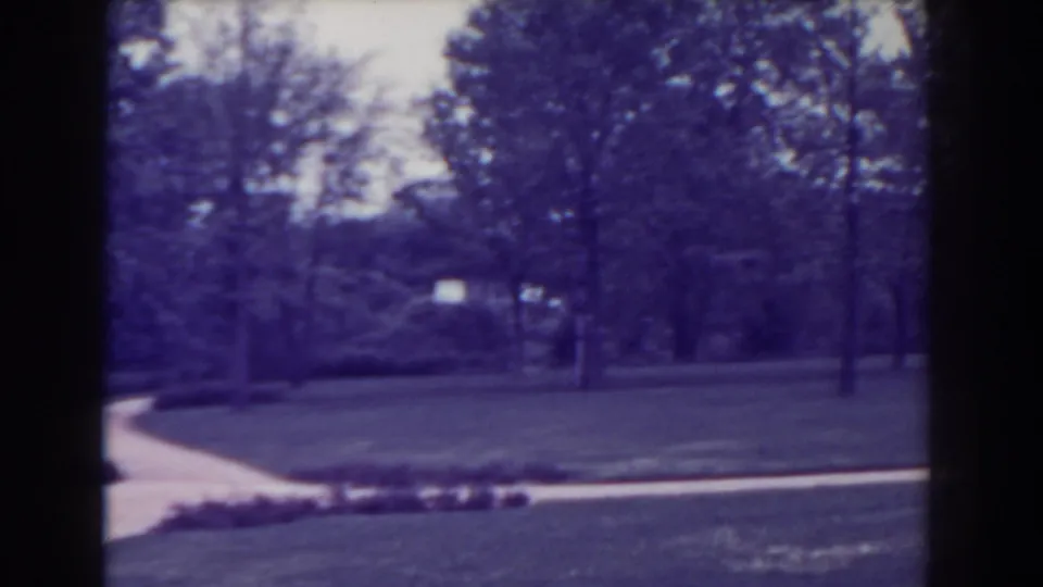 The Atlantic City park scene continues with a curved path, lawns, trees, and distant landscaping in soft 8mm focus.