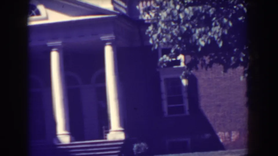 Soft 8mm frame of a columned porch and brick exterior in Atlantic City, New Jersey, 1938.