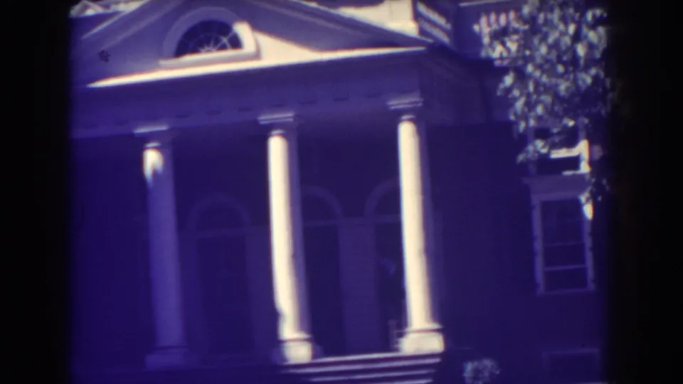 1938 Atlantic City frame showing a classical porch with two white columns and an arched entry.