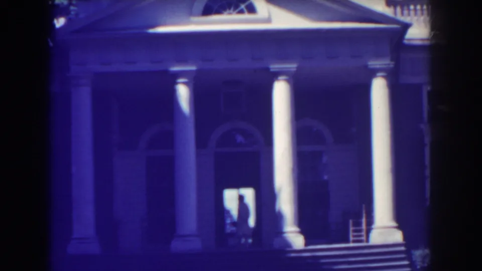 Atlantic City, 1938, with a columned building front, arched windows, broad entrance steps, and a silhouetted adult in the doorway.