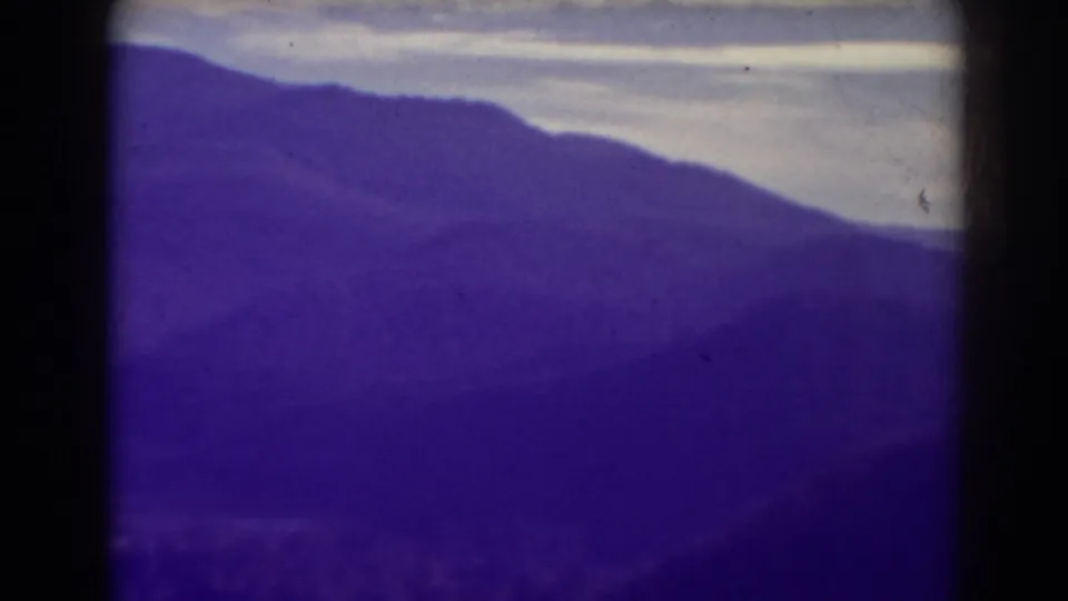 1938 West Virginia mountain view near Blackwater Falls, showing a sloped ridge and muted sky in soft 8mm color.