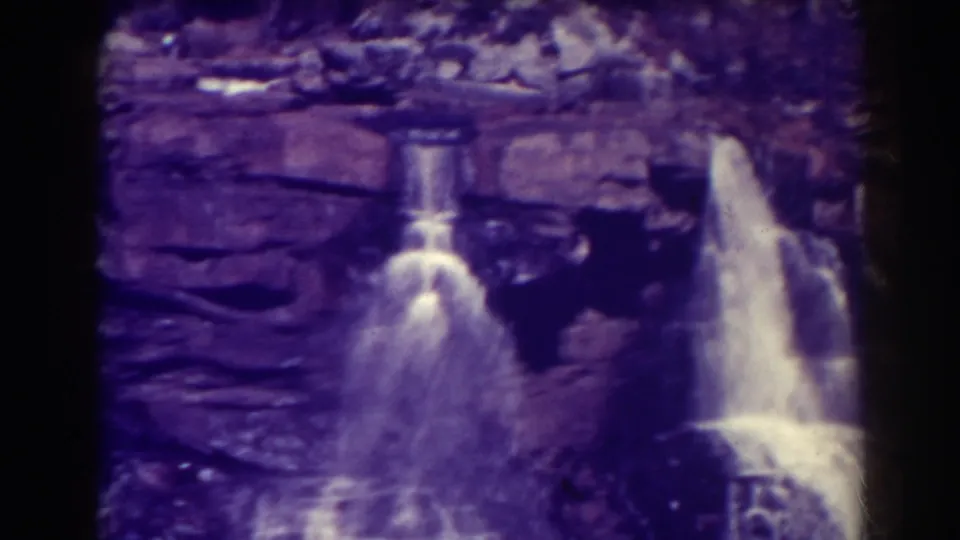 Blackwater Falls footage shows a central cascade and a larger fall at right, both flowing over dark layered rock.