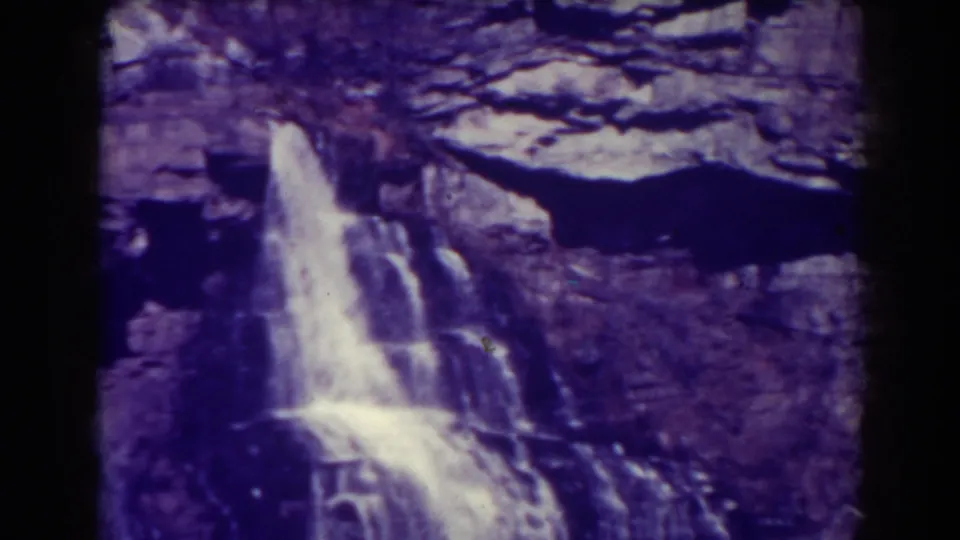 Final 8mm frame centers on the largest visible waterfall flowing over a rugged Blackwater Falls rock formation.