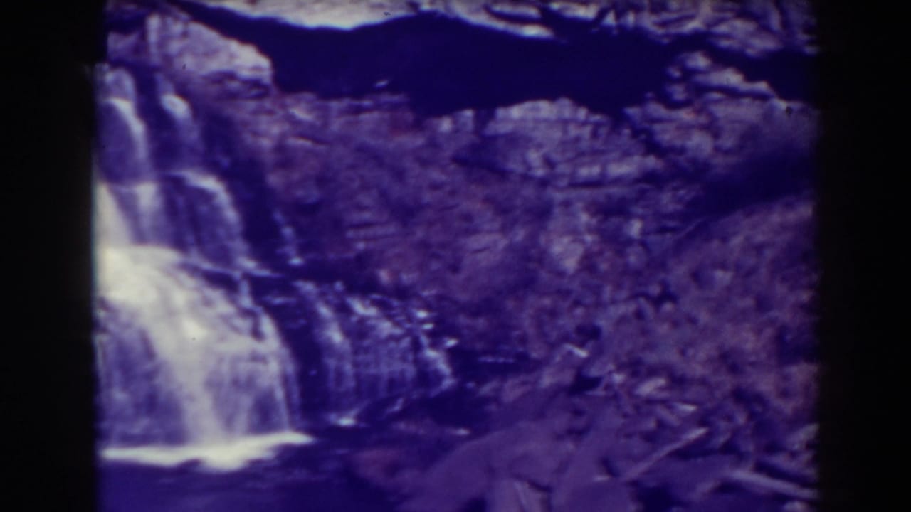 Blackwater Falls appears mid-pan, with white water crossing dark ledges and falling over the rugged West Virginia cliff.