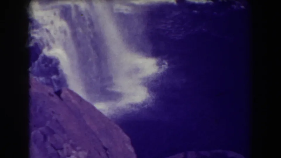 A closer lower view of Blackwater Falls shows falling white water beside a dark pool and sloped rock foreground.