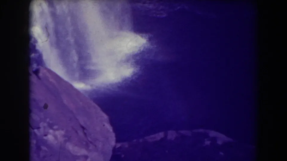 1938 8mm view at Blackwater Falls, West Virginia, showing water and cliff forms through a purple color cast.