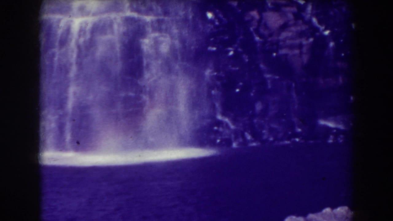 Blackwater Falls appears as a wide pale cascade against dark rock and water in this 1938 8mm home-movie frame.
