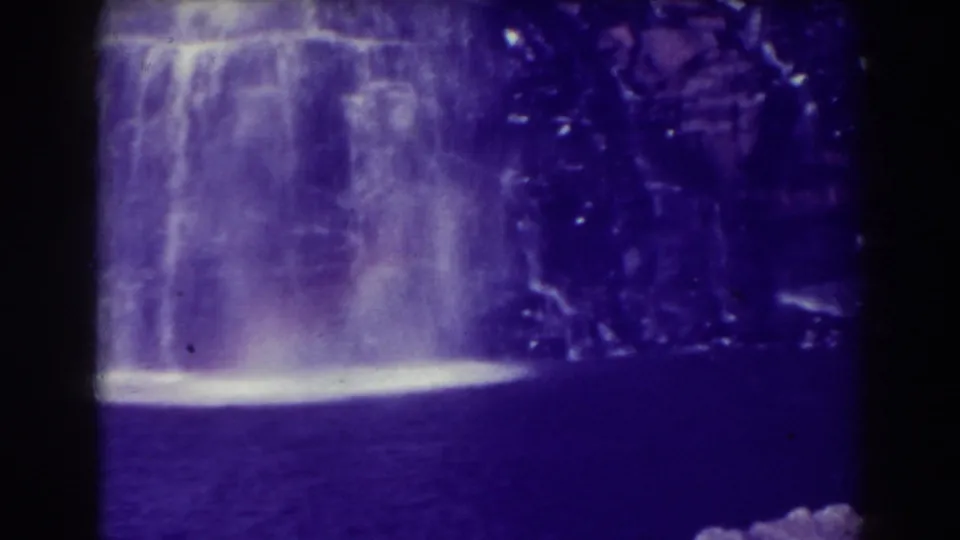 Blackwater Falls appears as a wide pale cascade against dark rock and water in this 1938 8mm home-movie frame.