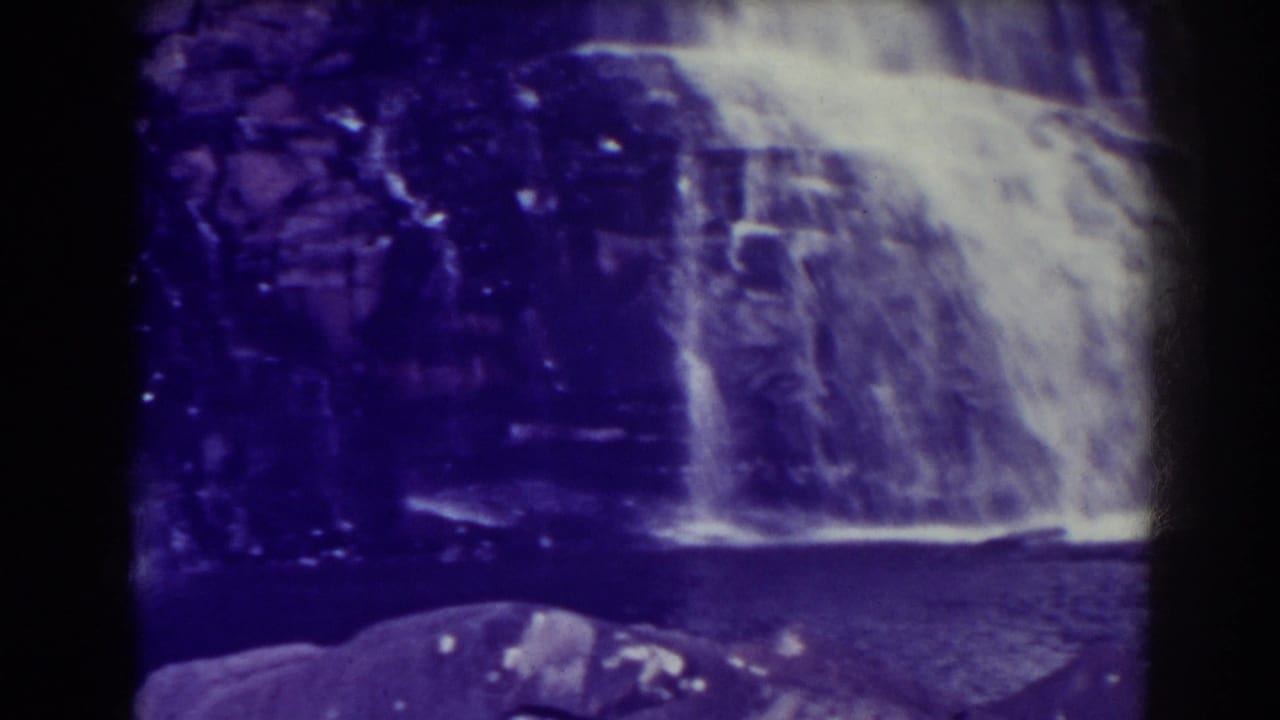 Blackwater Falls appears from a slightly shifted 8mm view, with bright water, dark stone, and foreground rocks.