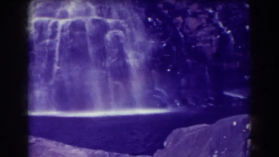 Late frame of the 8mm Blackwater Falls view, with broad white water against dark rock and purple aging color.